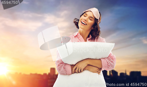 Image of woman with pillow in pajama and eye sleeping mask