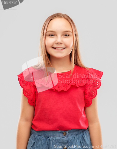 Image of beautiful smiling girl in red shirt and skirt