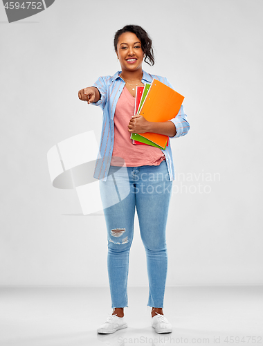 Image of african american student woman with notebooks