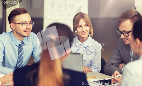 Image of smiling business people meeting in office