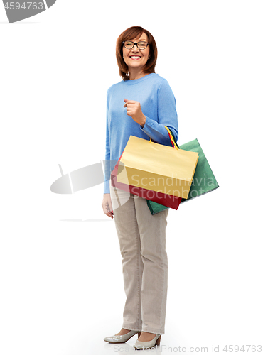 Image of senior woman with shopping bags isolated on white