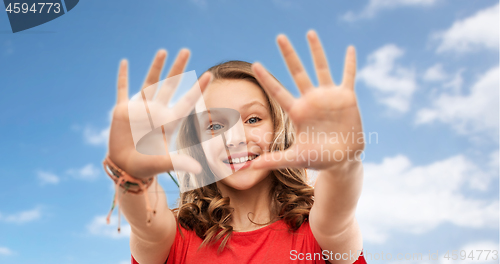 Image of happy teenage girl in red t-shirt giving high five