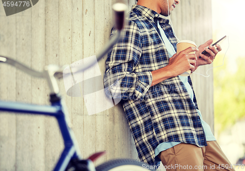 Image of man with earphones and smartphone listening music