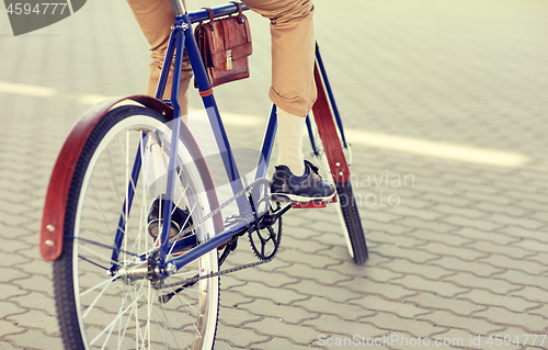 Image of close up of hipster man riding fixed gear bike