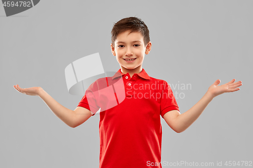 Image of smiling boy holding something on empty hands