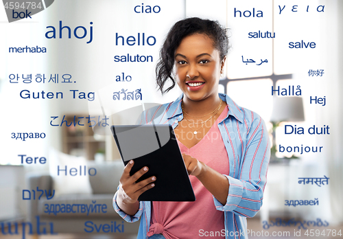 Image of happy african american woman using tablet pc