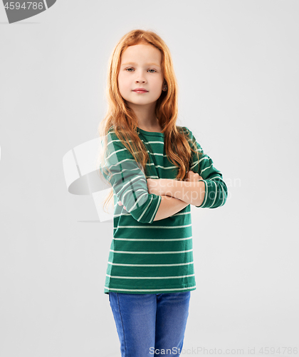 Image of confident red haired girl posing with crossed arms