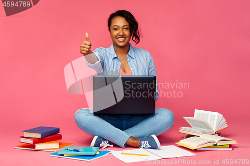 Image of happy african american student woman with laptop