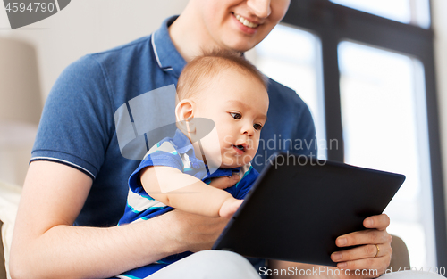 Image of happy father and baby son with tablet pc at home