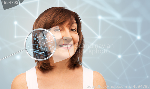 Image of senior woman with low poly grid in magnifier