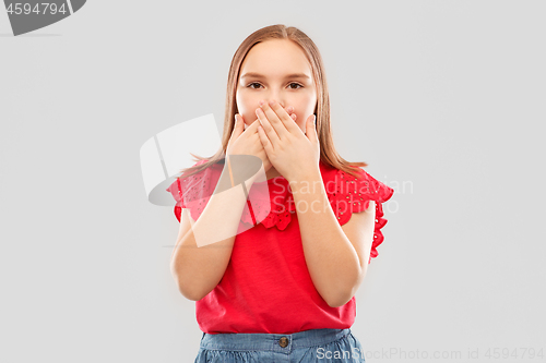 Image of confused girl covering her mouth by hands