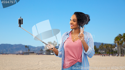 Image of african american woman taking selfie by smartphone