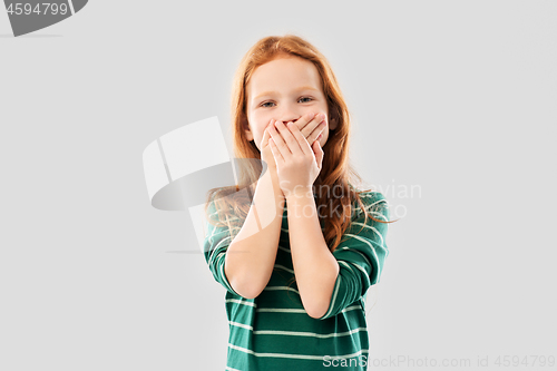 Image of confused red haired girl covering mouth by hands