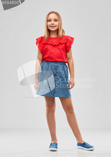 Image of beautiful smiling girl in red shirt and skirt