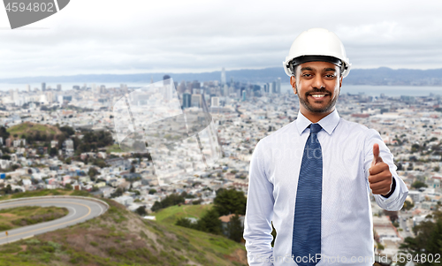 Image of architect or businessman in helmet shows thumbs up