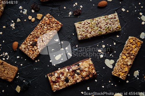 Image of Homemade gluten free granola bars with mixed nuts, seeds, dried fruits