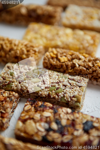 Image of Close up on healthy granola fit bars arragement. Placed on white table