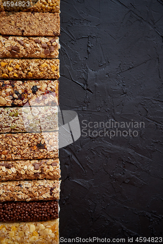 Image of Row of mixed gluten free granola cereal energy bars. With dried 