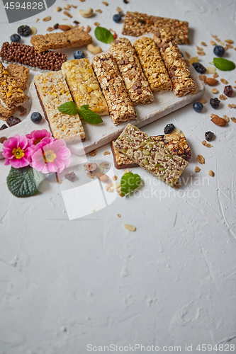 Image of Various kinds of protein granola bars with dry fruits and berries