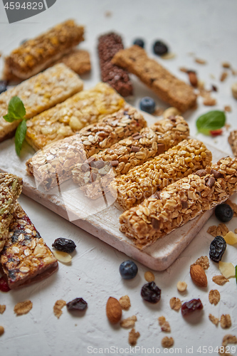 Image of Homemade gluten free granola bars with mixed nuts, seeds, dried fruits