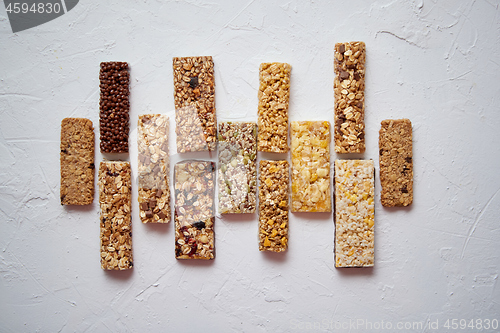 Image of Row of mixed gluten free granola cereal energy bars. With dried fruits and nuts.