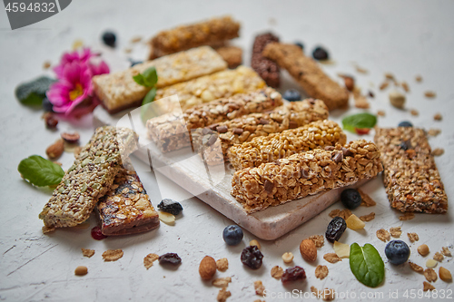 Image of Various kinds of protein granola bars with dry fruits and berries