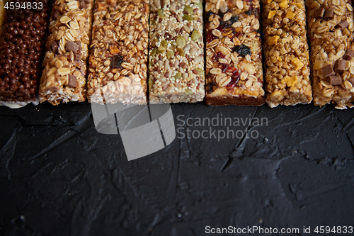 Image of Row of mixed gluten free granola cereal energy bars. With dried fruits and nuts.