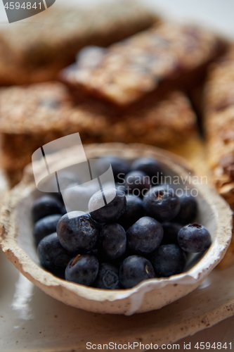 Image of Close up of blackberries. With various energy nutrition bars in background