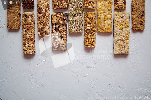 Image of Row of mixed gluten free granola cereal energy bars. With dried fruits and nuts.