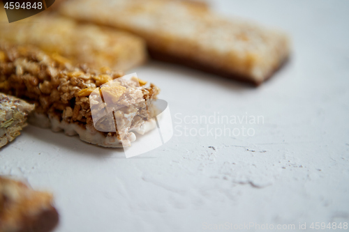 Image of Close up on healthy granola fit bars arragement. Placed on white table