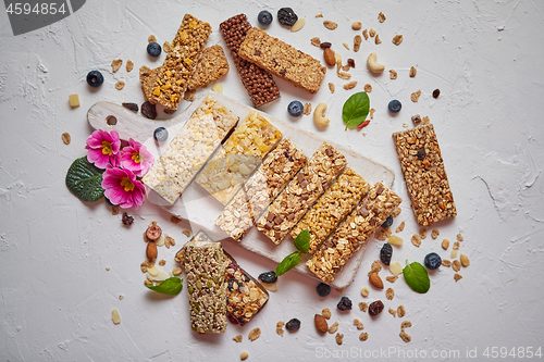 Image of Various kinds of protein granola bars with dry fruits and berries