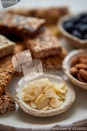 Image of Close up of Almond petals. With various energy nutrition bars in background