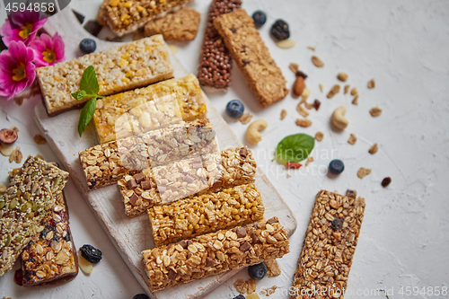 Image of Various kinds of protein granola bars with dry fruits and berries