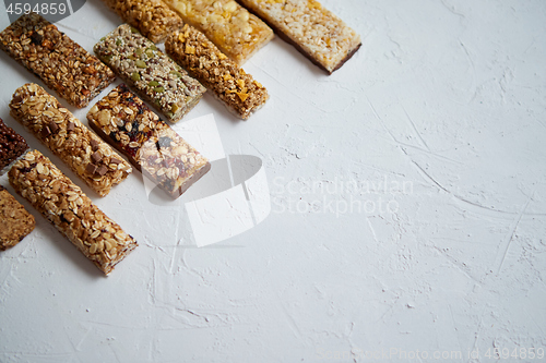 Image of Row of mixed gluten free granola cereal energy bars. With dried fruits and nuts.