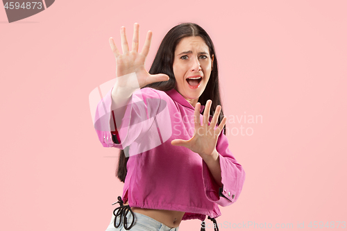 Image of Portrait of the scared woman on pink