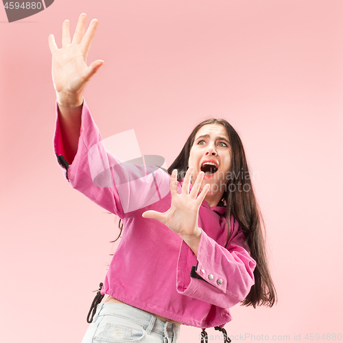 Image of Portrait of the scared woman on pink