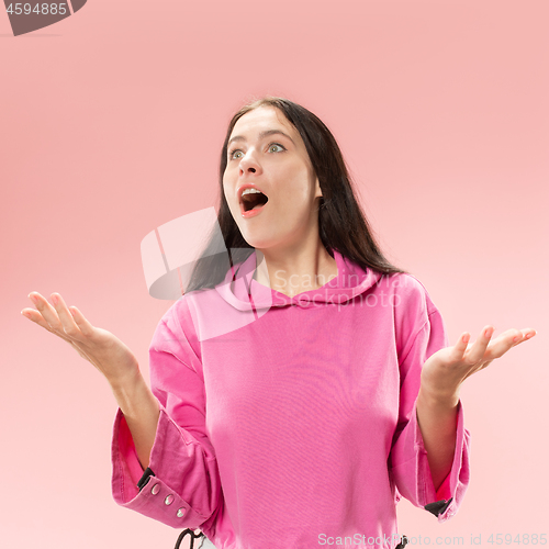 Image of Beautiful woman looking suprised isolated on pink