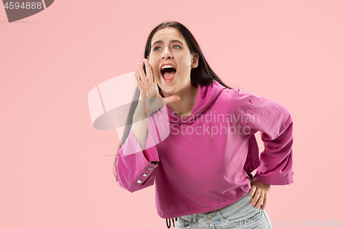 Image of Isolated on pink young casual woman shouting at studio