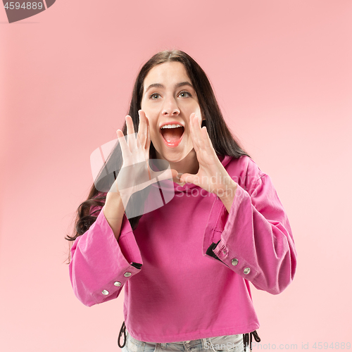 Image of Isolated on pink young casual woman shouting at studio