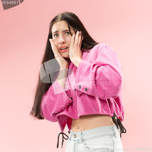 Image of Portrait of the scared woman on pink