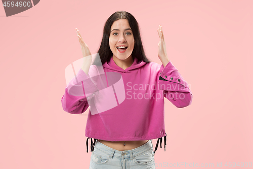 Image of Beautiful woman looking suprised isolated on pink