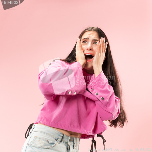 Image of Portrait of the scared woman on pink