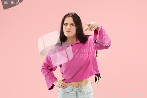 Image of The overbearing business woman point you and want you, half length closeup portrait on pink background.