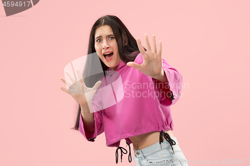 Image of Portrait of the scared woman on pink