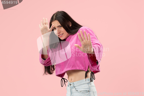 Image of Portrait of the scared woman on pink