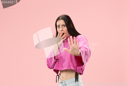 Image of Portrait of the scared woman on pink