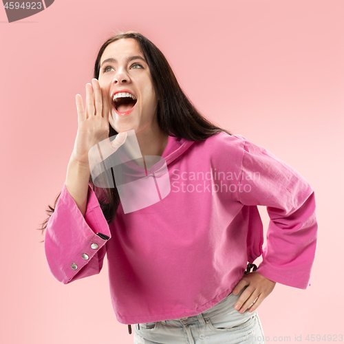 Image of Isolated on pink young casual woman shouting at studio