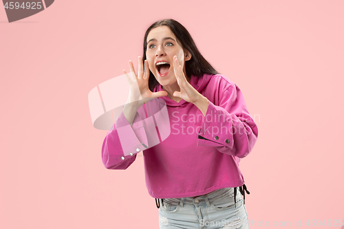 Image of Isolated on pink young casual woman shouting at studio