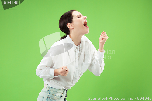 Image of Isolated on green young casual woman shouting at studio