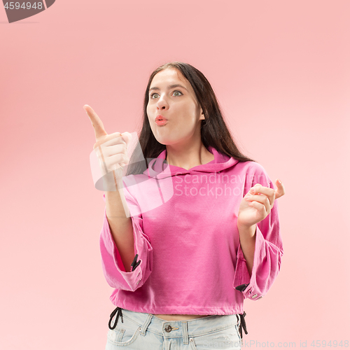 Image of Beautiful woman looking suprised isolated on pink